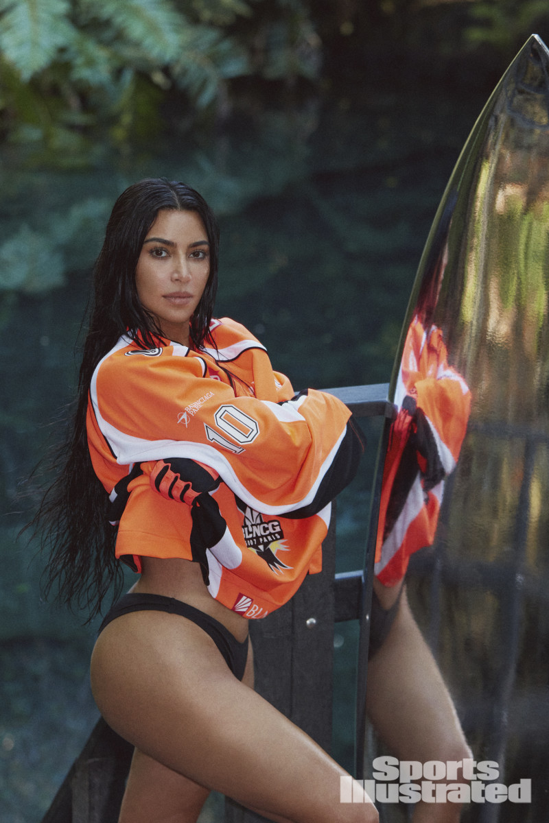 Kim Kardashian was photographed by Greg Swales in the Dominican Republic. Swimsuit by SKIMS. Top by Balenciaga. Gloves by Fox. 